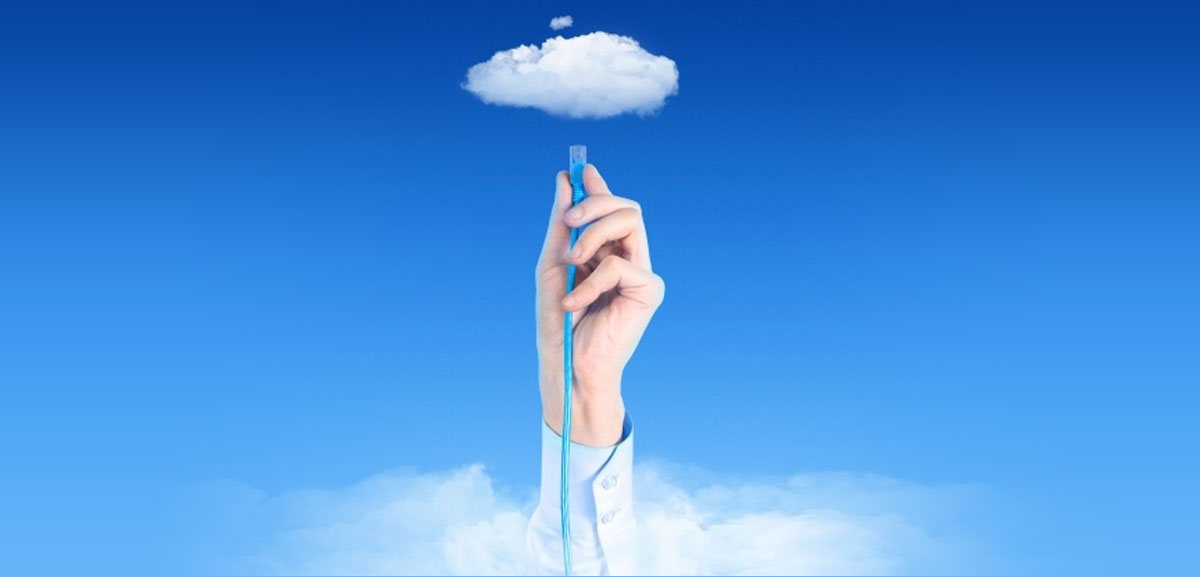 Cloud computing concept with hand plugging cord into cloud