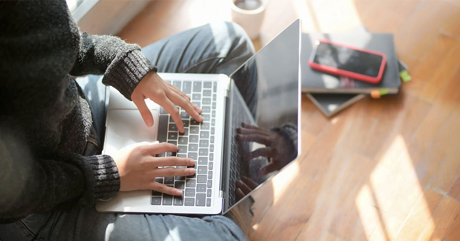 Woman working from home with Business Manager 365 on laptop