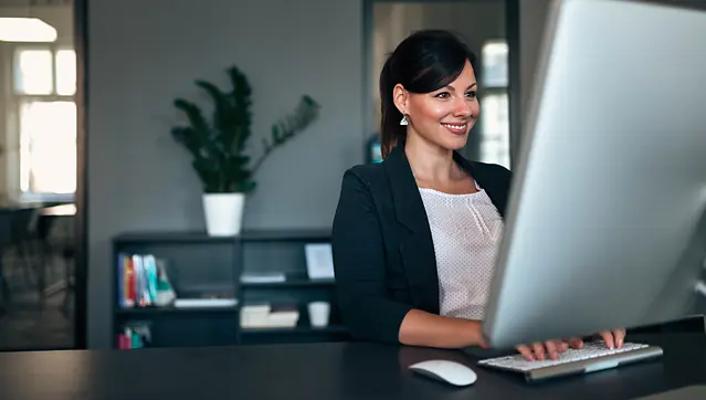 Happy Person Working On Computer At Humane Society Office